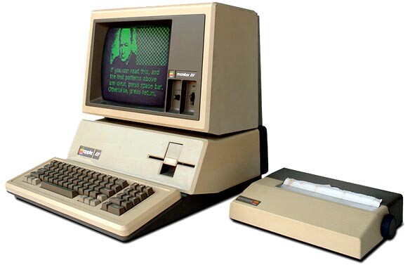 Um Apple III com monitor de fósforo verde, ao lado de uma impressora de 80 colunas