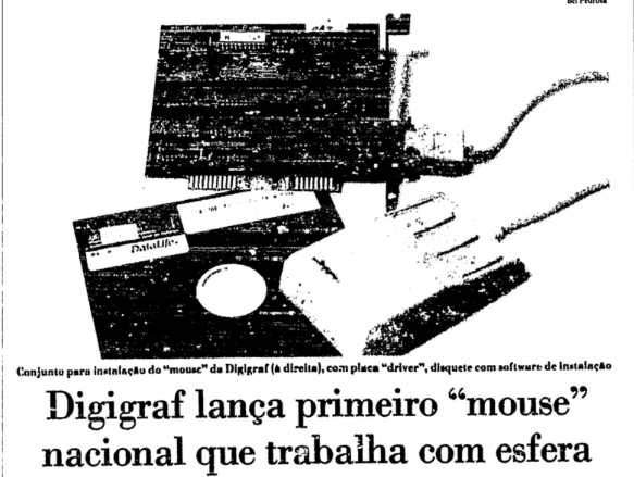 Matéria de jornal com foto do mouse, disquete, placa, e o título: Digigraf lança primeiro “mouse“ nacional que trabalha com esfera