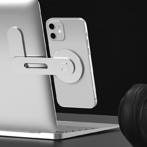 O suporte, preso a um notebook, com um celular preso magneticamente, visto por trás