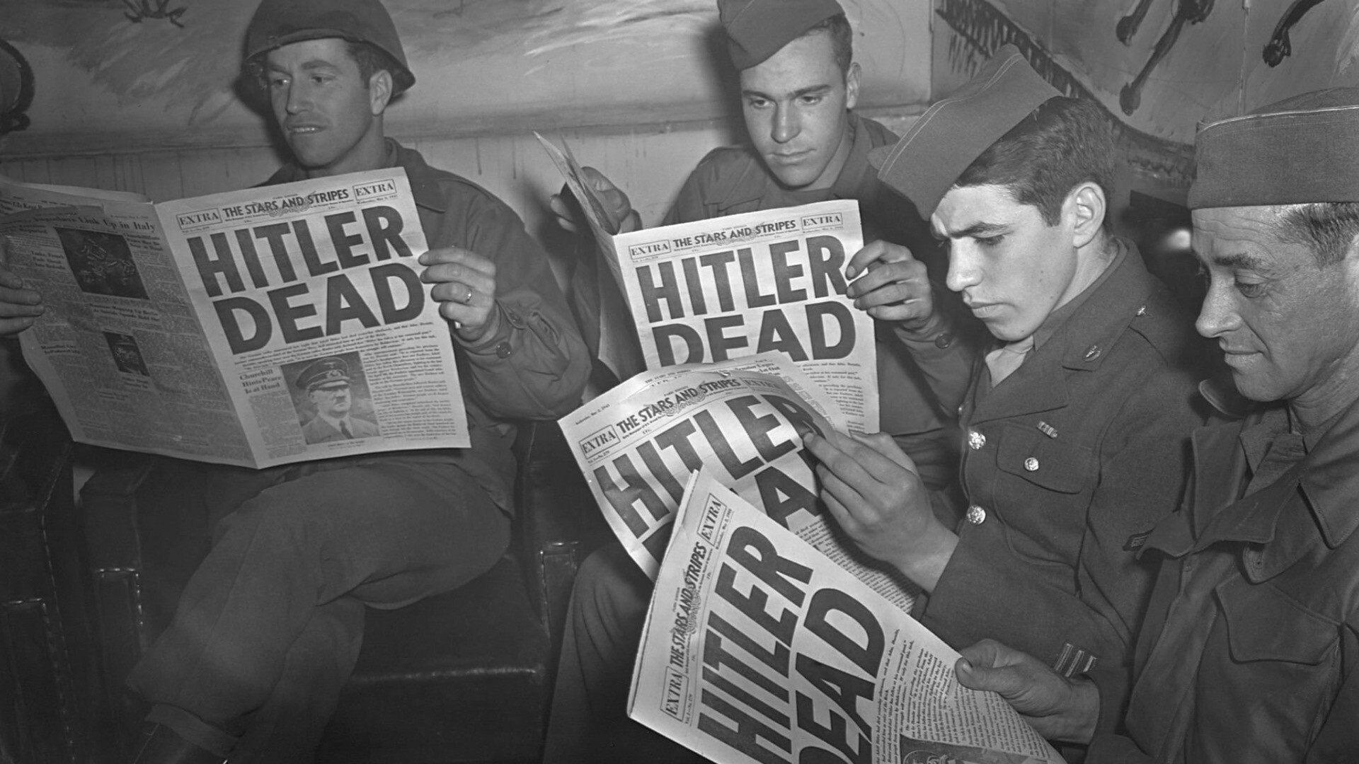 Militares dos EUA lêem jornais com a manchete “Hitler Dead“