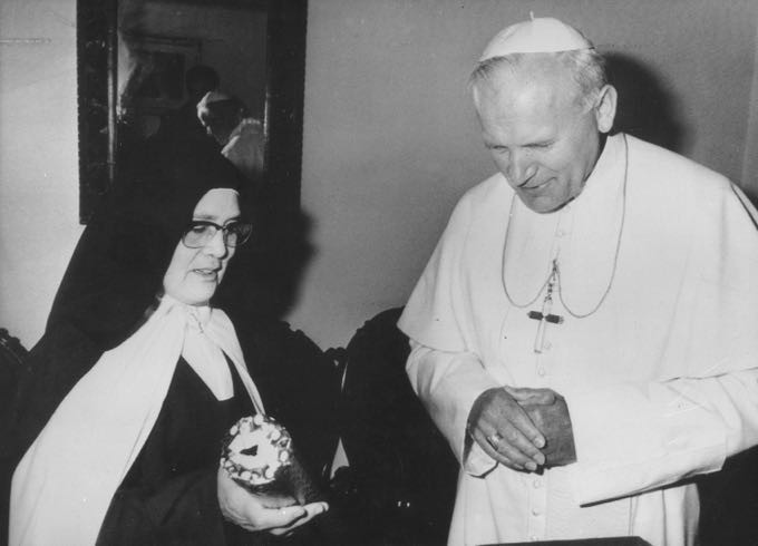 Foto em preto e branco do papa e da irmã Lúcia, ambos com seus trajes religiosos.